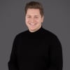 En profilbild av fastighetsmäklare Fredrik Holm