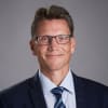 En profilbild av fastighetsmäklare Hans Edmark