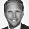 En profilbild av fastighetsmäklare Robert Nilsson
