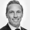 En profilbild av fastighetsmäklare Jonas Stalquist
