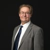 En profilbild av fastighetsmäklare Hans Genter