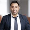 En profilbild av fastighetsmäklare Claudio Pino