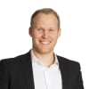 En profilbild av fastighetsmäklare Andreas E Olsson