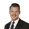 En profilbild av fastighetsmäklare Marcus Hermanson