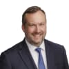 En profilbild av fastighetsmäklare Robert Kullberg