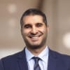 En profilbild av fastighetsmäklare Pezhman Pars