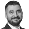 En profilbild av fastighetsmäklare Redir Ali