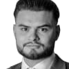 En profilbild av fastighetsmäklare Edison Kuci