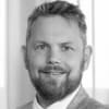 En profilbild av fastighetsmäklare Andreas Paulsson