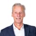 En profilbild av fastighetsmäklare Micael Arderup
