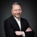 En profilbild av fastighetsmäklare Roger Axelsson