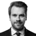 En profilbild av fastighetsmäklare Fredrik Thulin