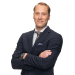 En profilbild av fastighetsmäklare Alexander Helin