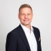 En profilbild av fastighetsmäklare Erik Moberg