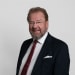 En profilbild av fastighetsmäklare Guy Wallster