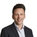 En profilbild av fastighetsmäklare Alex Lorant