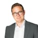 En profilbild av fastighetsmäklare Mikael Österling