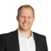 En profilbild av fastighetsmäklare Andreas E Olsson
