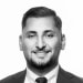 En profilbild av fastighetsmäklare Mehmet Budak