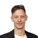 En profilbild av fastighetsmäklare Simon Claesson