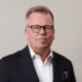 En profilbild av fastighetsmäklare Kenneth Parkegren