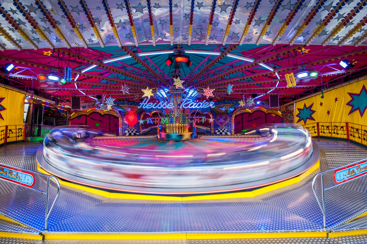 Photo of a carousel in action. The rotational movement creates a fuzzy effect: it is impossible to know with certainty the speed of the merry-go-round.