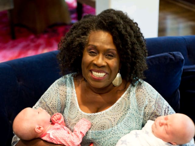 Cheryl Abrams postpartum doula has a set of twins in her arms