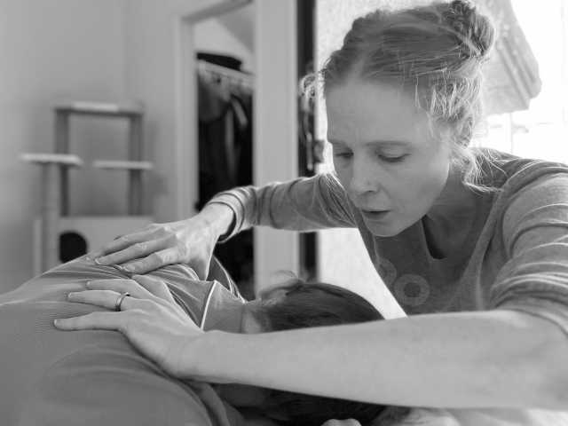 Doula providing shoulder massage during labor