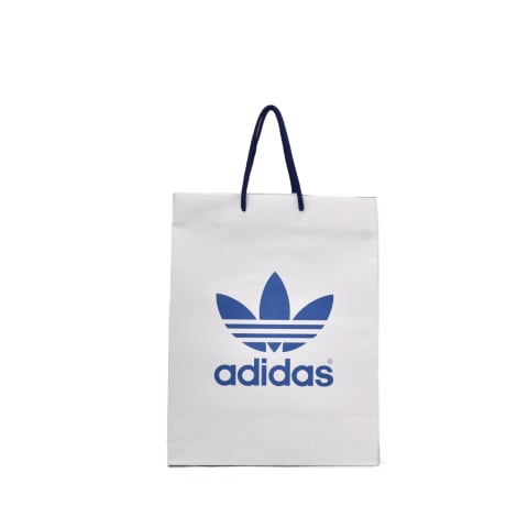 Bolsa de papel Bond blanca impresa a una tinta azul con logotipo de: Adidas.