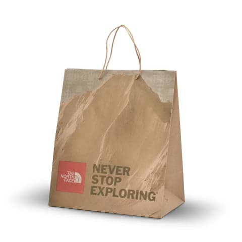 Bolsa tipo Kraft color natural  impresa con la marca: The North Face.
