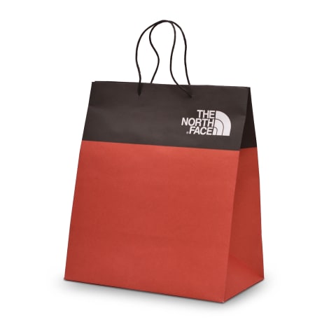 Bolsa Kraft impresa en color rojo con negro con el logotipo de: The North Face.