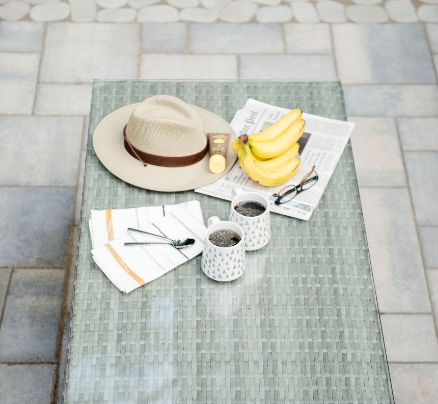 Morning coffee setup on a paver patio with outdoor furniture