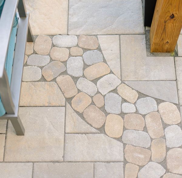 Bluestone patio with brick border and potted plants