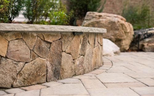 Stone veneer retaining and sitting wall