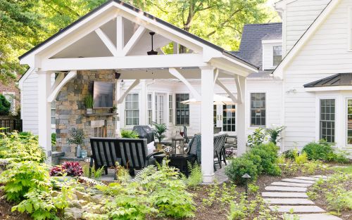 White patio pavilion on a paver patio with landscaping