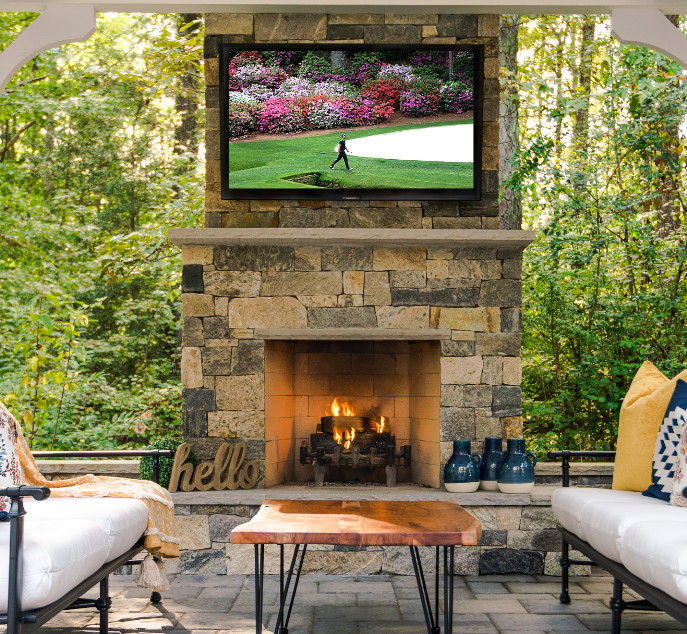 Outdoor fireplace with outdoor television playing the masters tournament