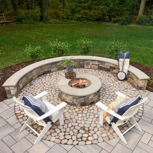 paver patio with stone fire pit and sitting wall