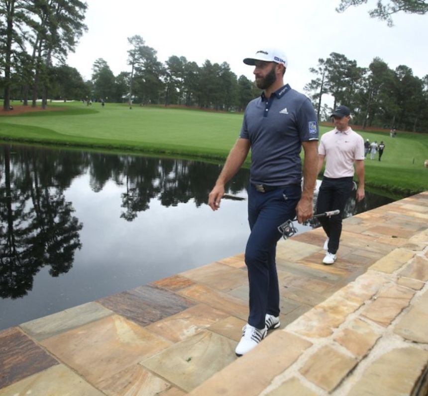 Golfer crosses the Sarazen Bridge at Augusta National