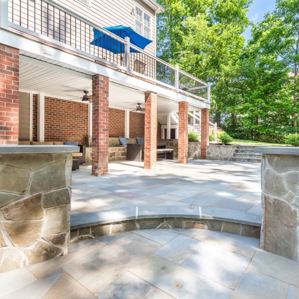 Paver patio with sitting walls and a covered patio