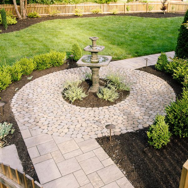 paver patio circular design with water fountain