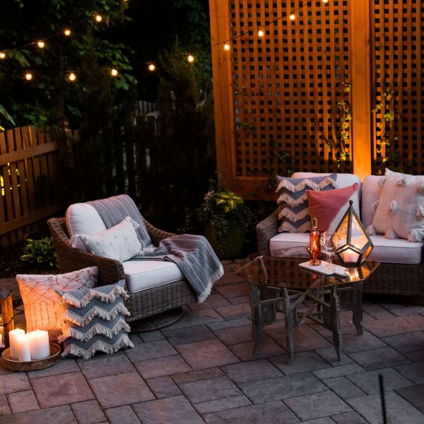 Paver patio with wood trellis privacy screens and string bistro lights