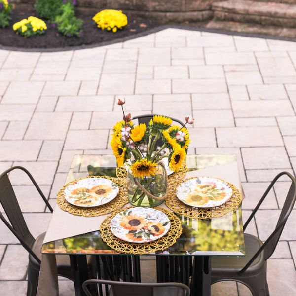 backyard patio pavers with table set with sunflowers