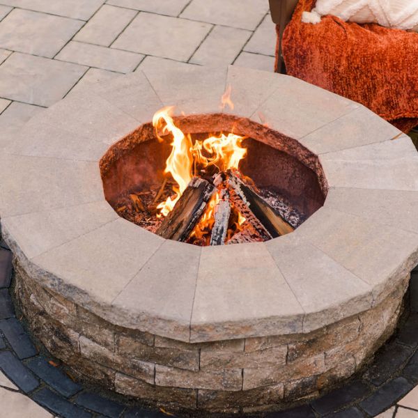 custom fire pit installed into backyard patio