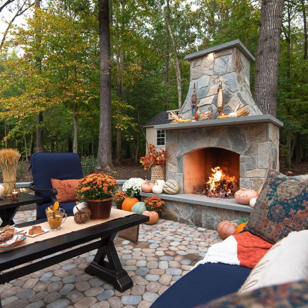 Fall decorations by the outdoor stone fireplace