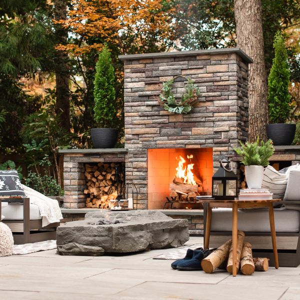 Large stacked veneer fireplace with storage for logs on both sides