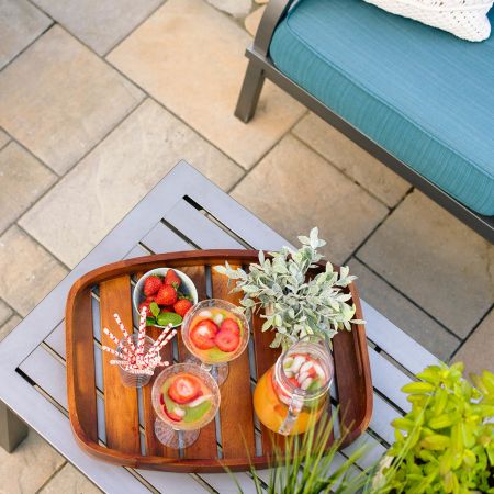 natural stone pavers are under the teal lounge chair and drink station
