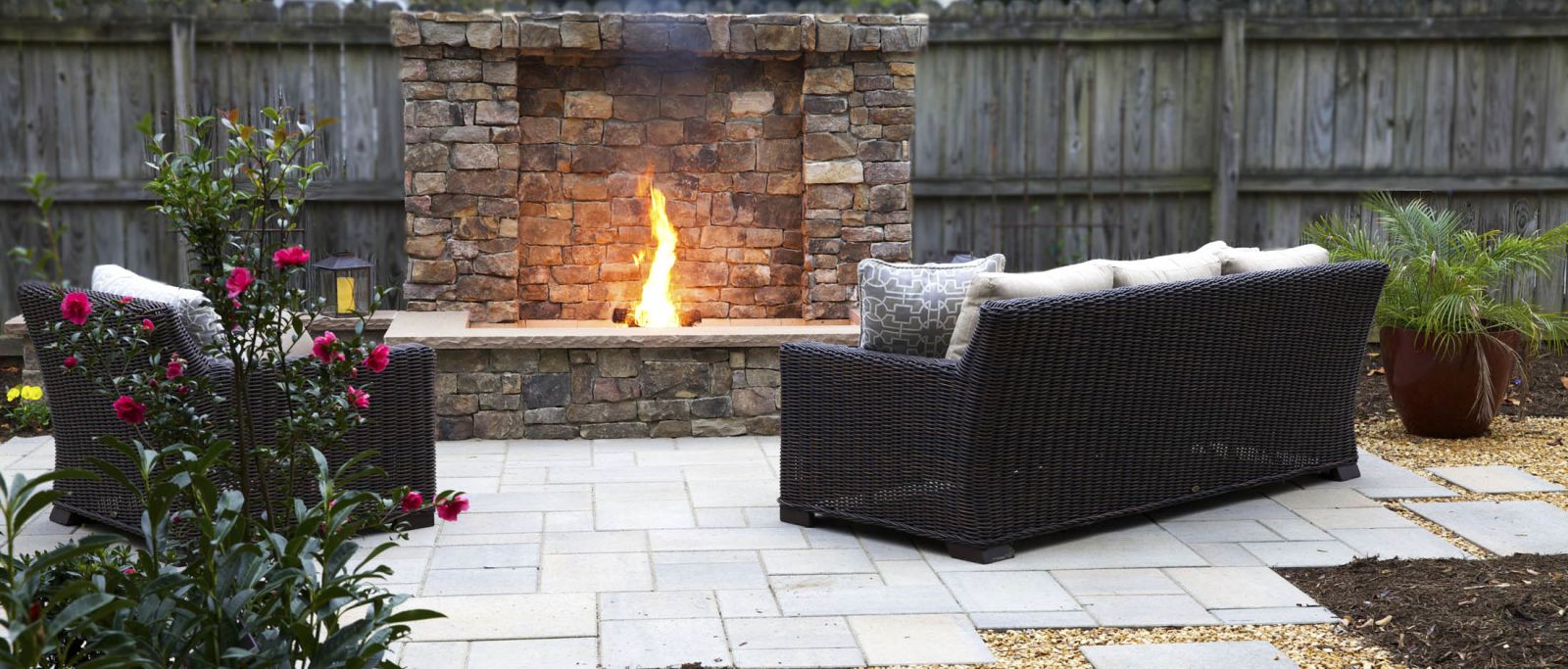 Stone Fireplace outside on pavers and stone landscaped yard