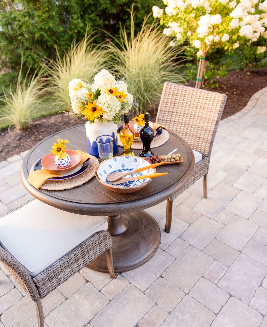 Romantic dinner for two with cut flowers on a paver patio