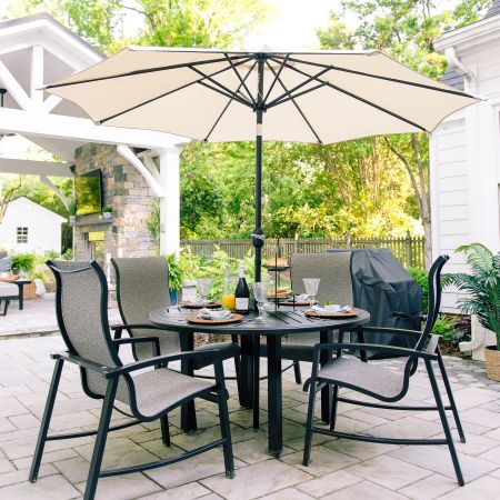 this outdoor table and chairs is shaded by the umbrella