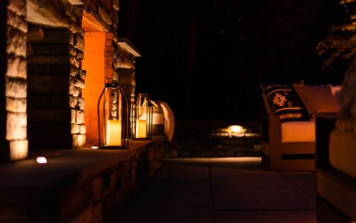 Outdoor lighting with stone outdoor fireplace